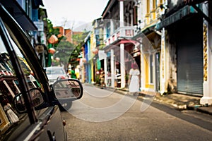 Focus at sideview mirror of a car in phuket old town.