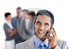 Focus on a smiling businessman on phone