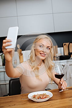 Focus of smiling woman taking selfie