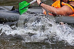 Focus some part of young person rafting on the river