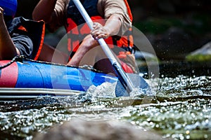 Focus some part of young person are rafting in river.