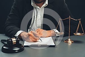 Focus symbols of justice on blurred background of lawyer signing. equility