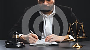 Focus symbols of justice on blurred background of lawyer signing. equility