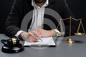 Focus symbols of justice on blurred background of lawyer signing. equility