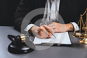 Focus symbols of justice on blurred background of lawyer signing. equility