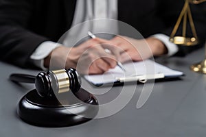 Focus symbols of justice on blurred background of lawyer signing. equility