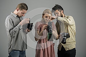 Focus on what matters. Paparazzi or photojournalists with vintage old cameras. Group of photographers with retro cameras