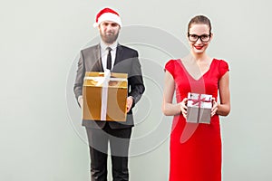 Focus on woman. Couple showing colorful box and smiling