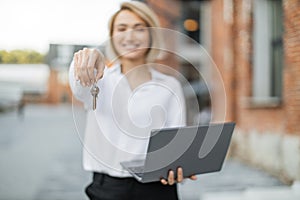 Focus on woman hand with keys.