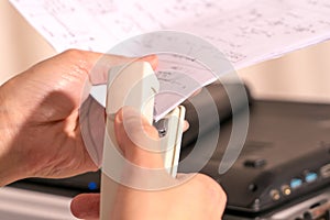 Focus on the women hand stapling the handwriting paper, working and office concept