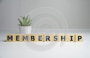 focus on wooden blocks with letters making Membership text. Concept image