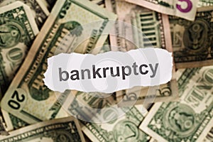 Focus on the word BANKRUPTCY on piece of torn white paper with b