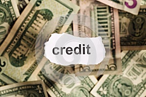 Focus on the word CREDIT on piece of torn white paper with blur