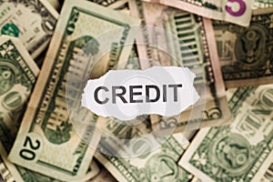 Focus on the word CREDIT on piece of torn white paper with blur