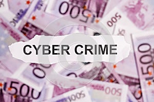 Focus on the word CYBER CRIME on piece of torn white paper with