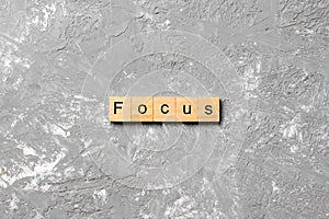 Focus word written on wood block. focus text on table, concept