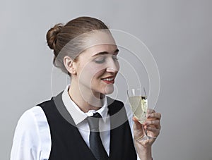 Focused 20s girl tasting bubbly wine at party to celebrate success at becoming sommelier