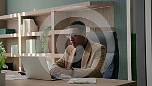 Focused African American man businessman working with corporate documents sales research professional employer office