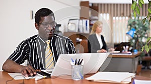 Focused african american man working at office desk