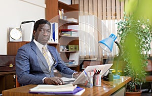 Focused african american man working at office desk