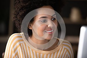 Focused African American student girl working at computer
