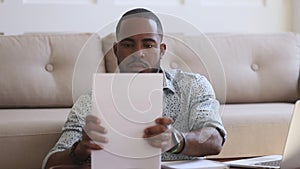 Focused african man student freelancer typing on laptop doing paperwork