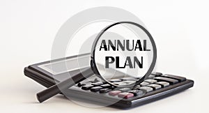 Focused on ANNUAL PLAN concept. Magnifier glass with text on calculator. Business concept