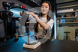 Focused barista brewing a caffeinated beverage at the bar counter