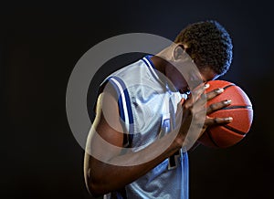 Focused basketball player with ball in studio