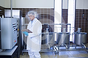 Focused biologist with safety gloves holding clipboard