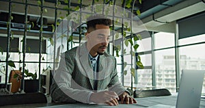 Focused businessman analyzing documents in modern office photo