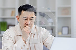 Focused businessman contemplating while working at desk