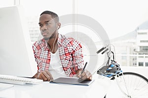 Focused businessman listening music and using digitizer