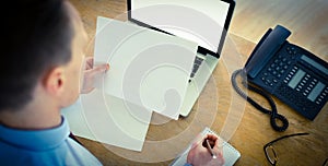 Focused businessman reading document at desk