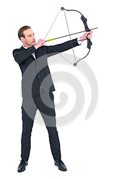 Focused businessman shooting a bow and arrow