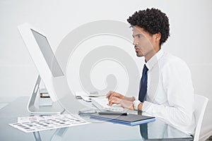 Focused businessman typing on keyboard