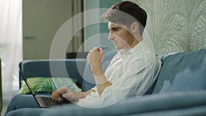 Focused businessman working laptop in hotel room. Man typing computer hotel room