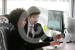 Focused businesspeople brainstorm working on laptop in office