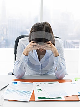 Focused businesswoman checking financial reports and thinking