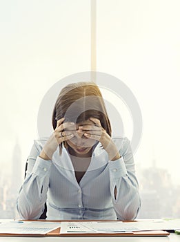 Focused businesswoman checking financial reports and thinking