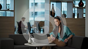 Focused businesswoman using computer in office. Serious lady looking screen