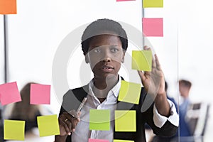 Focused busy African employee using scrum method, task management tools