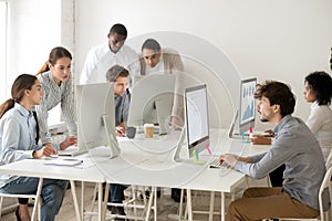 Focused multiracial business people working online on computers photo