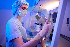 Focused calm lab worker is preparing biological material for storage