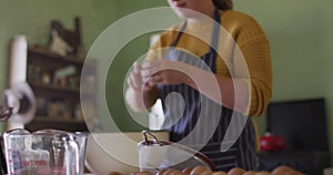 Focused caucasian woman baking in kitchen