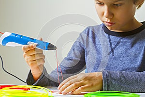 Focused child creating with 3d printing pen