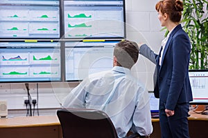 Focused colleagues analyzing result on their computer