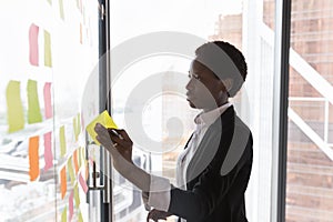 Focused confident Black business leader woman preparing project plan