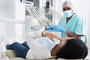 Focused dentist listening to female patient toothache complains