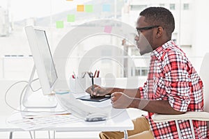 Focused designer using digitizer and computer photo